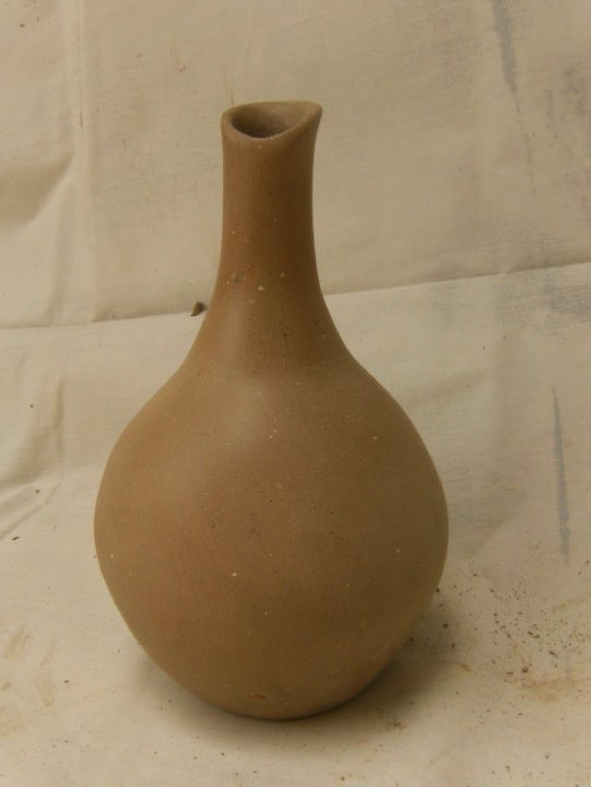 Slender hand-built terracotta bottle form