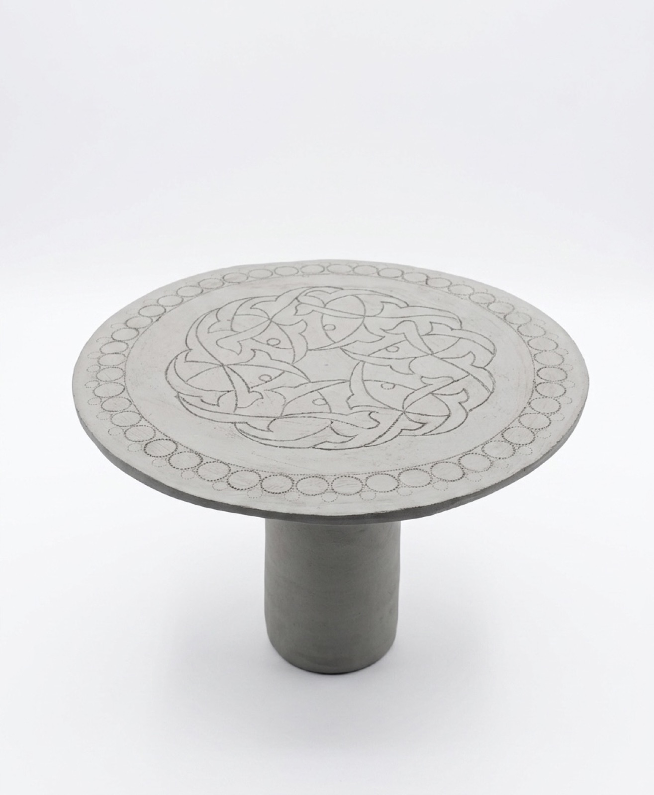 Grey footed plate carved with knotted kufic calligraphy