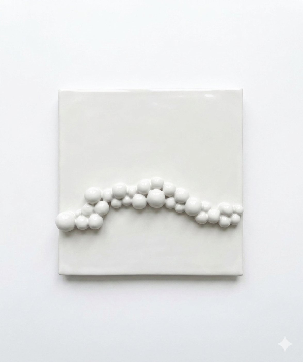 White glossy ceramic tile with a raised wave of glazed spheres
